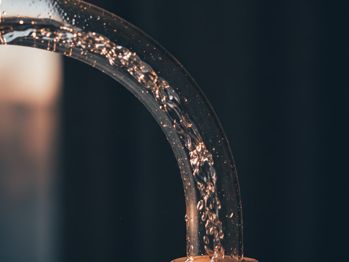 Water flowing through a clear pipe without collecting in it